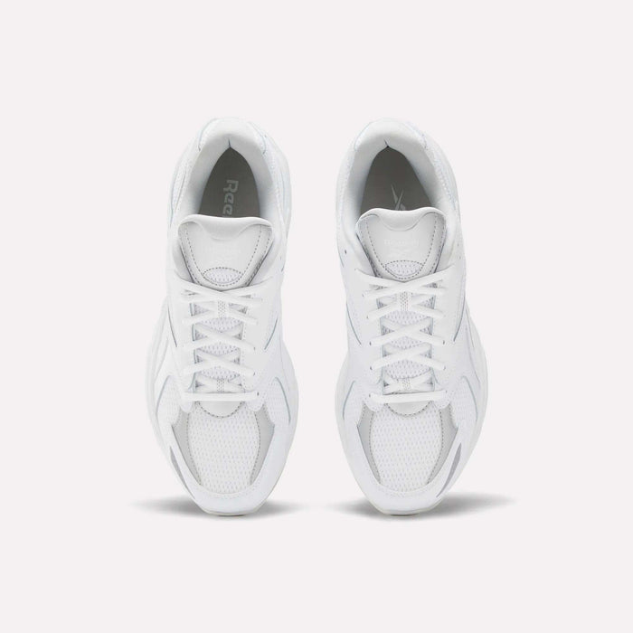 A pair of white Reebok Road Prime Shoes seen from above, highlighting the laces, mesh panels, and smooth overlays on a plain white background for a classic Y2K running style.