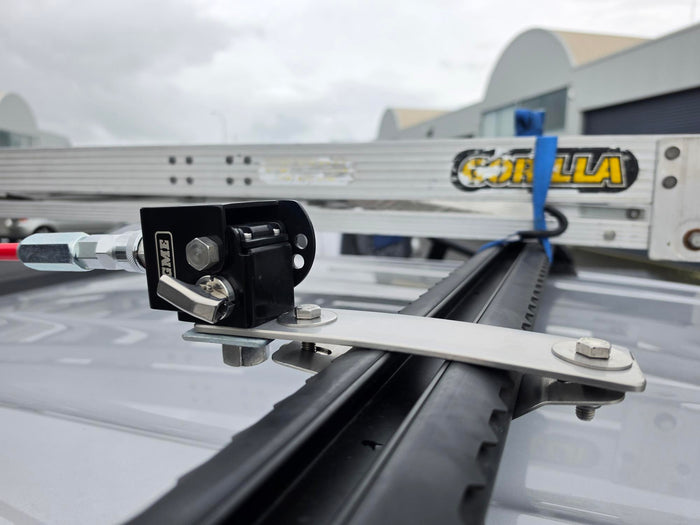 Close-up of a black and silver roof rack mounting bracket attached to a vehicle roof rack