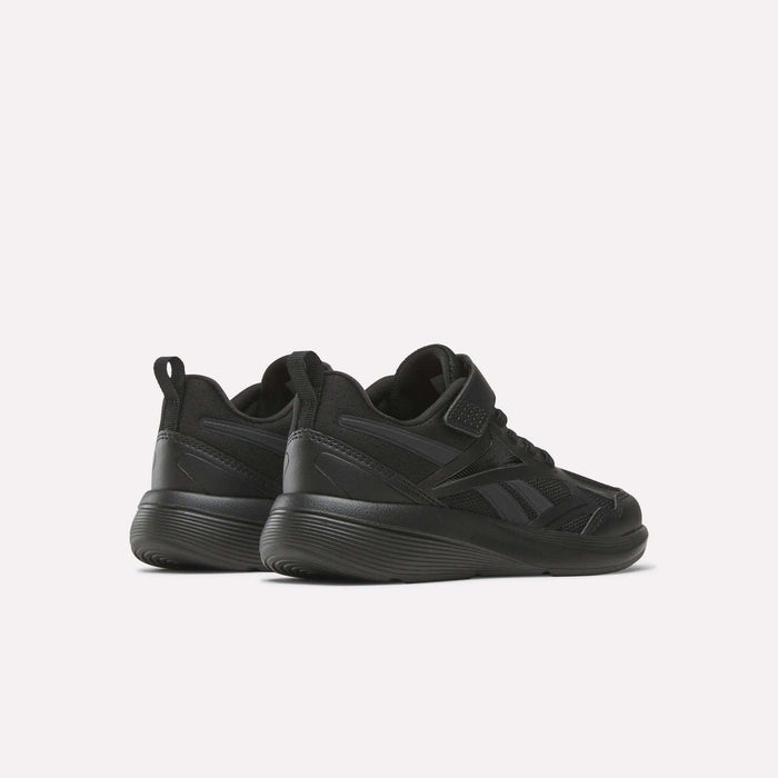 A pair of black Reebok Rush Runner 6.0 Elastic Lace Top Strap Running Shoes for little kids, shown from a rear-side angle on a light background. These low-top shoes have thick soles and subtle panel details, ideal for all-day play.