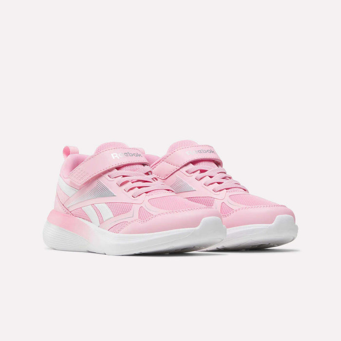 The Reebok Rush Runner 6.0 Elastic Lace Top Strap Running Shoes for little kids in pink and white feature velcro straps and laces, making them perfect running shoes for girls, shown on a white background.