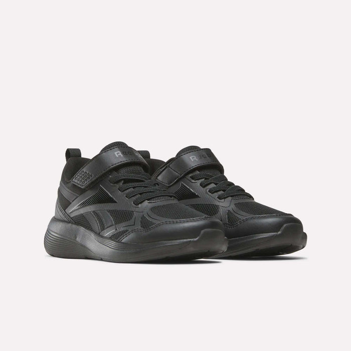 The Reebok Rush Runner 6.0 Elastic Lace Top Strap Running Shoes for little kids feature a black design with Velcro and laces, a textured sole, and subtle details—perfect for all-day play, shown against a plain light background.