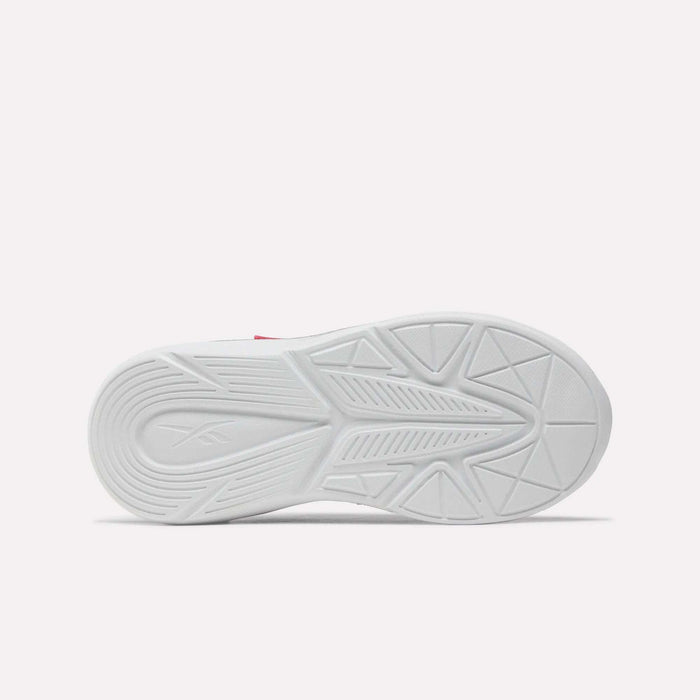 Bottom view of the Rush Runner 6.0 Elastic Lace Top Strap Running Shoes for little kids by Reebok, showing a white rubber sole with geometric tread patterns and a subtle logo on the heel, inspired by classic Reebok designs against a plain light background.