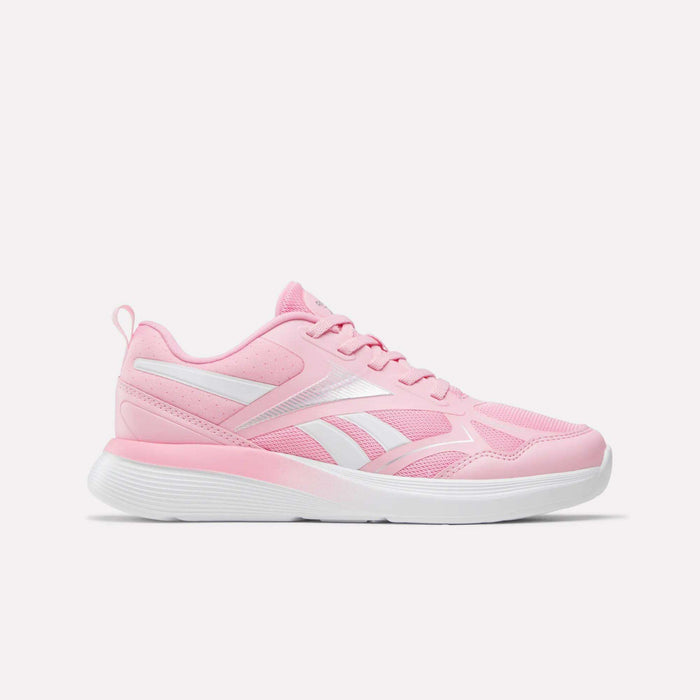 The Reebok Rush Runner 6.0 Running Shoes for big kids, in Expressive Pink and Ftwr White, feature white accents and a white EVA midsole, shown from the side against a plain white background.