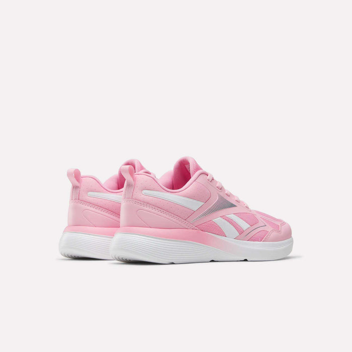 A pair of Reebok Rush Runner 6.0 Running Shoes for big kids in pink and white with white EVA midsoles, shown from the back and side on a plain white background.