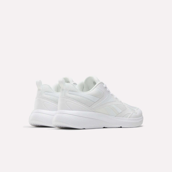 The Reebok Rush Runner 6.0 Running Shoes for big kids are white athletic sneakers with lace-up fronts, EVA midsoles, and textured soles, displayed on a plain white background to show their sides and backs.