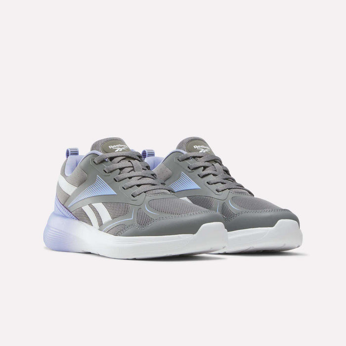 A pair of Reebok Rush Runner 6.0 Running Shoes for big kids in gray and white with purple accents, featuring mesh uppers, cushioned EVA midsoles, white soles, and laces. The athletic shoes are displayed side by side on a plain white background.
