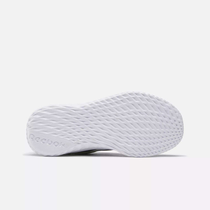 Bottom view of Reebok Rush Runner Slip-On Shoes for little kids, showing a textured, diamond-patterned sole for traction and lightweight cushioning. The embossed Reebok logo appears near the heel. Background is plain white.