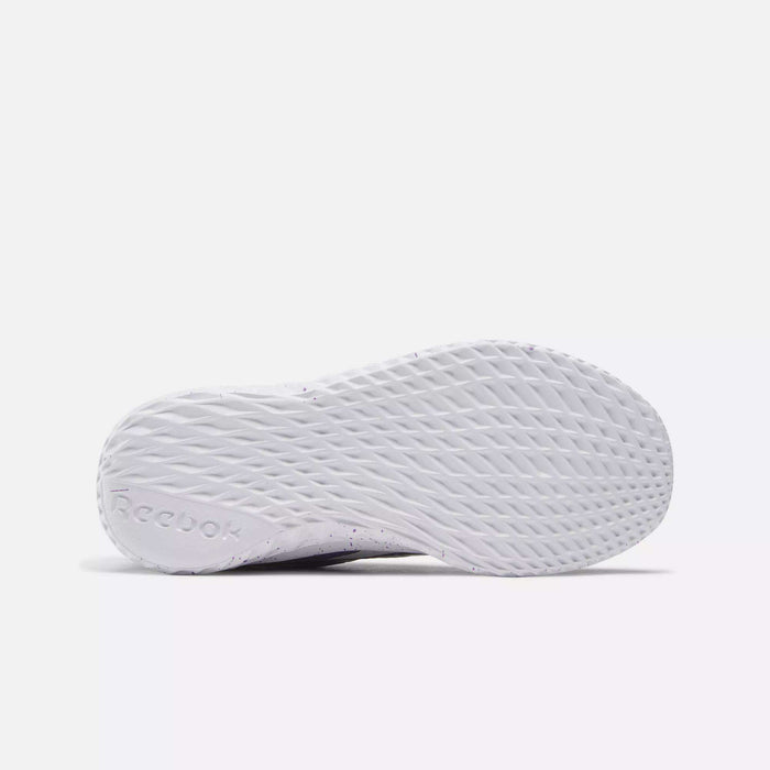 The image shows the textured white sole of Reebok Rush Runner Slip-On Shoes for little kids, viewed from below. The wavy, crisscross tread pattern and embossed logo emphasize grip and style perfect for girls' running shoes.
