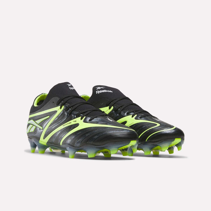 The Reebok Sidewinder 26 Elite FG Cleats in black and neon green feature textured uppers for enhanced ball control and molded studs, making them ideal for firm grass play. Shown on a light background.