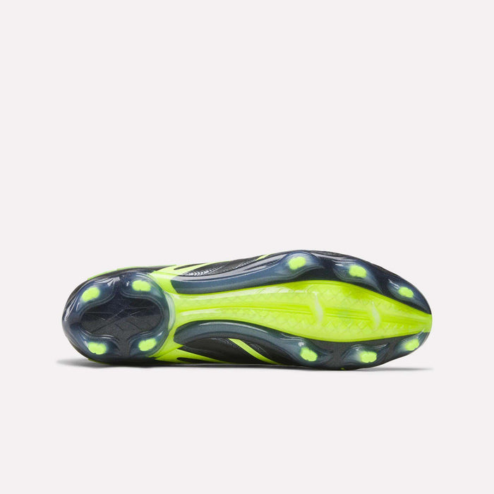 Bottom view of the Reebok Sidewinder 26 Elite FG Cleats showing a black and neon yellow sole designed for firm grass, with six round studs and textured grip patterns to boost traction and ball control.