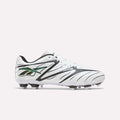 The Reebok Sidewinder 26 League Firm Ground Cleats for big kids are shown in a white, black, and silver colorway, featuring black side patterns and molded studs designed for firm ground play, set against a plain light background.