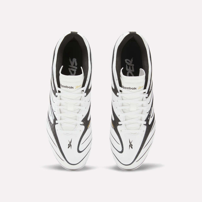 Top view of a pair of Reebok Sidewinder 26 League Firm Ground Cleats for big kids in white, featuring black and gold accents. The image highlights the laces, Reebok logo, design details, and firm ground studs against a plain white background.