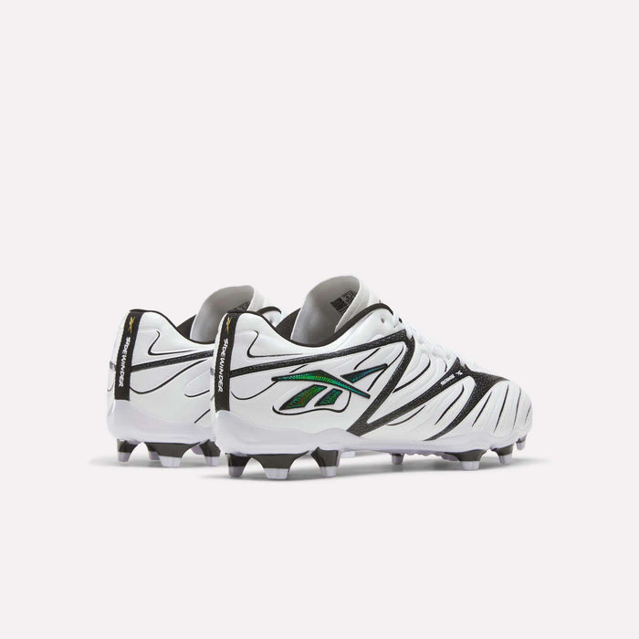 A pair of Reebok Sidewinder 26 League Firm Ground Cleats for big kids in white with black and green accents, featuring firm ground studs and shown slightly angled apart on a plain white background.