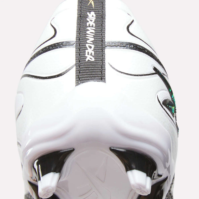 Close-up of the heel and firm ground studs of a white Reebok Sidewinder 26 League Firm Ground Cleat for big kids, featuring black and gray details. A SKYHUNTER text appears on a gray strip running vertically up the shoe’s back, highlighting the precision design characteristic of kids’ Reebok cleats.