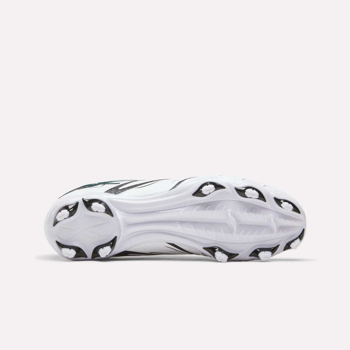 The image shows the bottom view of the Reebok Sidewinder 26 League Firm Ground Cleats for big kids, featuring a white design with black accents and firm ground studs for optimal traction on athletic fields.