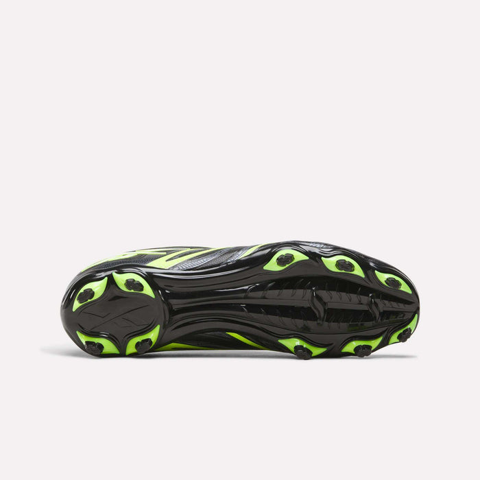 The image shows the sole of the Reebok Sidewinder 26 League FG Cleats for big kids, featuring a black base with neon yellow accents and several firm ground studs for dependable traction on the field.