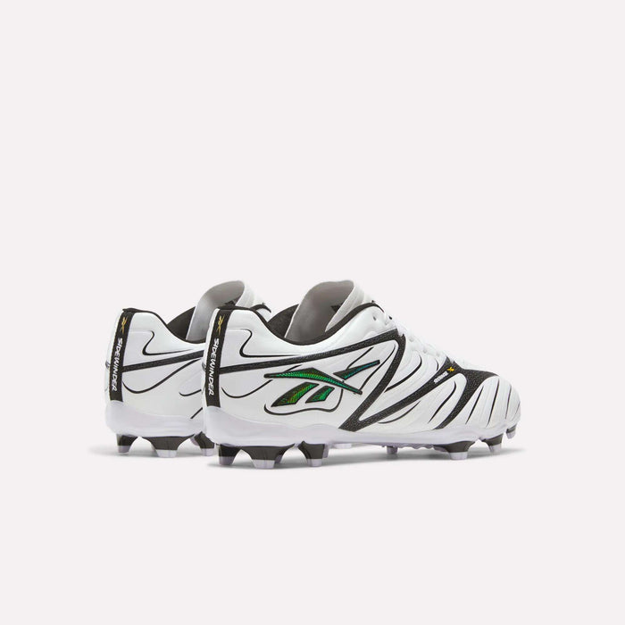 A pair of Reebok Sidewinder 26 League Firm Ground Cleats in white with black and green accents, shown from the back and side to highlight their firm ground studs for improved traction, displayed against a plain white background.