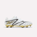 The Reebok Sidewinder 26 Pro Firm Ground Cleats are shown in profile on a plain background. Featuring a white upper with black and silver accents, these cleats include the signature Reebok logo in black and silver, a lace-up closure, and molded studs on the sole designed for enhanced ball control.