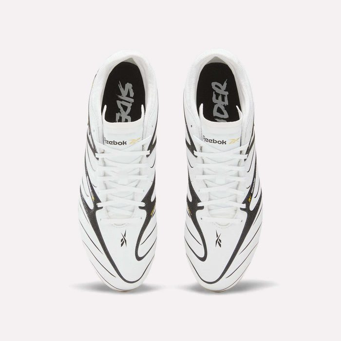 A pair of Reebok Sidewinder 26 Pro Firm Ground Cleats in white with black and gold accents, seen from above on a plain background. Inspired by classic soccer cleats made for ball control on firm ground, the insoles feature the word “SIDER” in a stylized font.