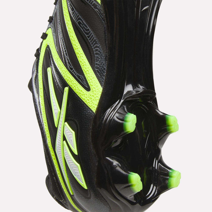 Close-up of the sole of the Reebok Sidewinder 26 Pro FG Cleats in black with neon green accents, designed for firm ground. Features three prominent studs and textured patterns to enhance ball control.