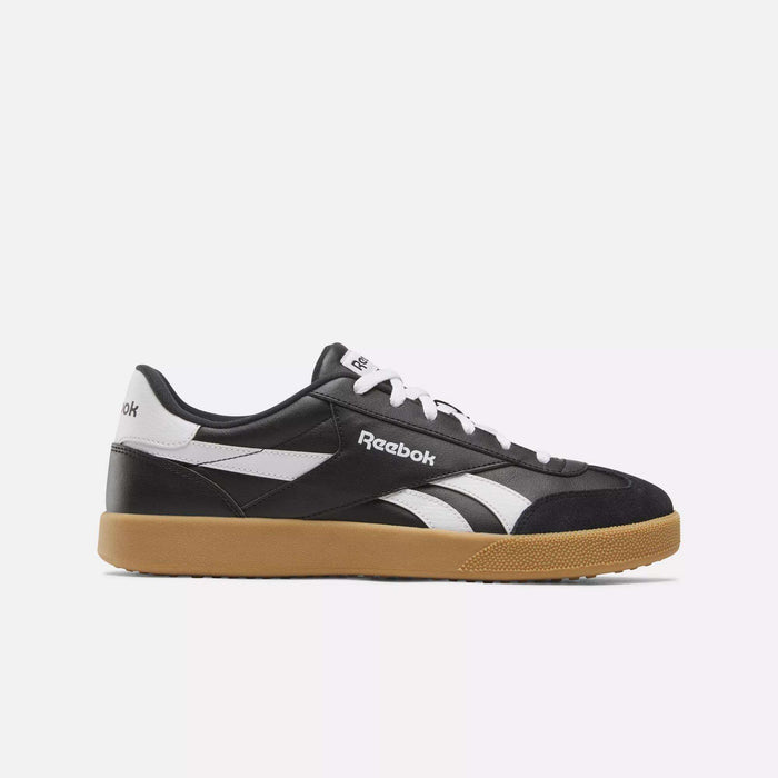The Reebok Smash Edge Shoes are black and white sneakers with a minimalist design, white laces, a white Reebok logo, and a light brown rubber sole, shown in side profile against a plain white background.