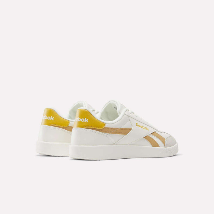 Reebok Smash Edge Shoes in white with yellow accents and beige stripes—ideal for indoor soccer. Displayed from the back and side on a plain white background.