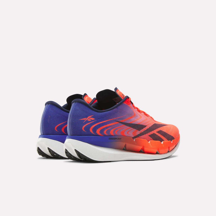 A pair of Reebok SpeedShifter Running Shoes, showcasing a vibrant gradient that fades from bold red-orange at the toe to deep purple at the heel, features black and white soles, dynamic wave side patterns, and responsive HyperFloat foam to deliver enhanced comfort and performance.