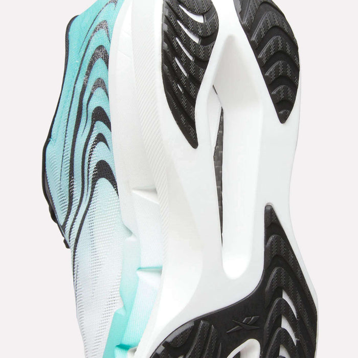 Close-up of the sole of a Reebok SpeedShifter Running Shoe in white and aqua, featuring black wavy tread patterns and textured grip that showcase the outsole design, HyperFloat foam cushioning, and advanced comfort.