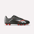 The Reebok Strike Multi Ground Soccer Cleats in black and red feature a durable synthetic upper with striking white and red accents, the iconic Reebok logo, and bold red studs on the sole. Displayed against a plain white background, these high-performance cleats are perfect for athletes seeking reliable turf soccer shoes.