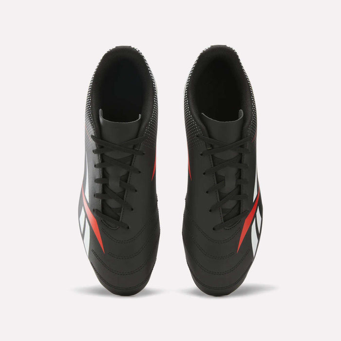 A pair of Reebok Strike Multi Ground Soccer Cleats with a synthetic upper in black, featuring white and red accents, viewed from above on a plain white background.