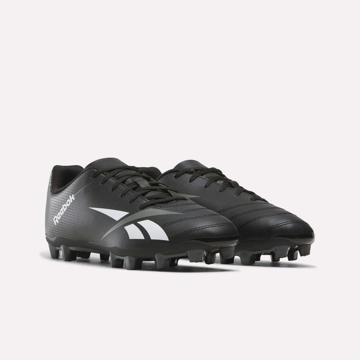 A pair of Reebok Strike Multi Ground Soccer Cleats in black, showcasing white Reebok logos, equipped with laces and studded soles suited for turf use, displayed against a plain white background.
