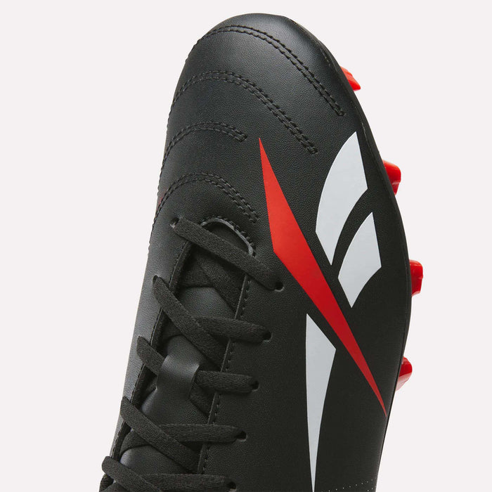 Close-up of the Reebok Strike Multi Ground Soccer Cleats in black, featuring a synthetic upper with a red and white geometric design on the side, black laces, and red studs visible at the bottom right edge.