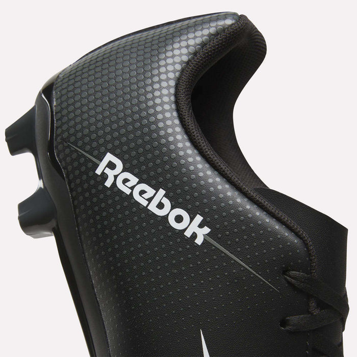 Close-up of a black Reebok Strike Multi Ground Soccer Cleat designed for turf, featuring a dot pattern, white Reebok logo, and part of the cleat studs visible on the left side.