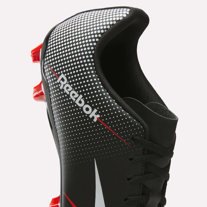 A close-up of the Reebok Strike Multi Ground Soccer Cleats in black, featuring a synthetic upper with white dots, red accents, and red studs. The iconic Reebok logo stands out on the side, highlighting the signature style of Reebok soccer footwear.