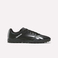 The Reebok Strike Turf Soccer Shoes in Black/White, featuring a white logo and accents, are designed for turf sports and perfect for soccer practice. Shown here is a side profile view on a plain white background.