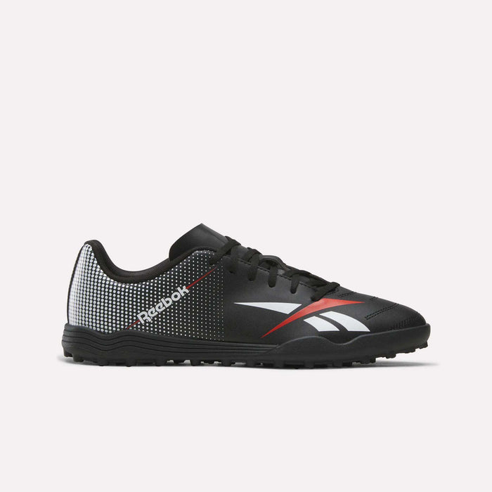 The Reebok Strike Turf Soccer Shoes in Black/Red feature white and red accents, a dotted pattern on the heel, and a white Reebok logo on the side. Shown against a plain white background, these stylish soccer shoes deliver both performance and flair—ideal for practice or playing on turf.