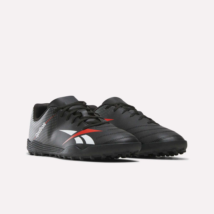 The Reebok Strike Turf Soccer Shoes are a pair of black athletic footwear accented with white and red details, featuring textured soles and the Reebok logo on the side, displayed against a plain white background.