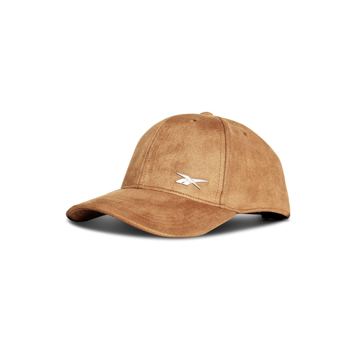 The Reebok Suede Badge Cap features brown vegan suede, a curved brim, and a small white embroidered logo on the front—ideal for everyday or fitness wear.