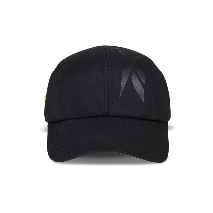 Front view of the Reebok Technical Running Cap With Drawcord in black, featuring a glossy graphic on the right crown, visible seam stitching, and crafted from recycled materials for an eco-friendly running hat.