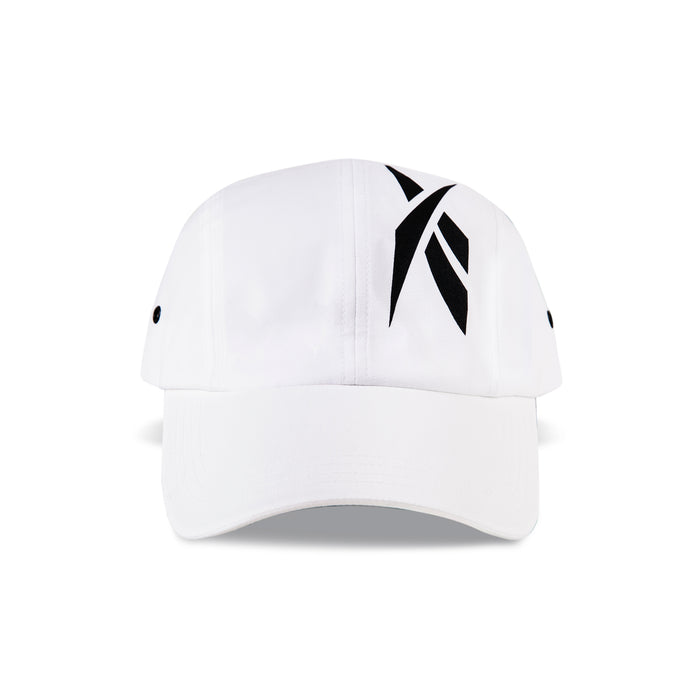 The Reebok Technical Running Cap With Drawcord is a white eco-friendly cap with a black abstract logo, crafted from recycled materials. It includes ventilation eyelets and is shown against a plain white background.