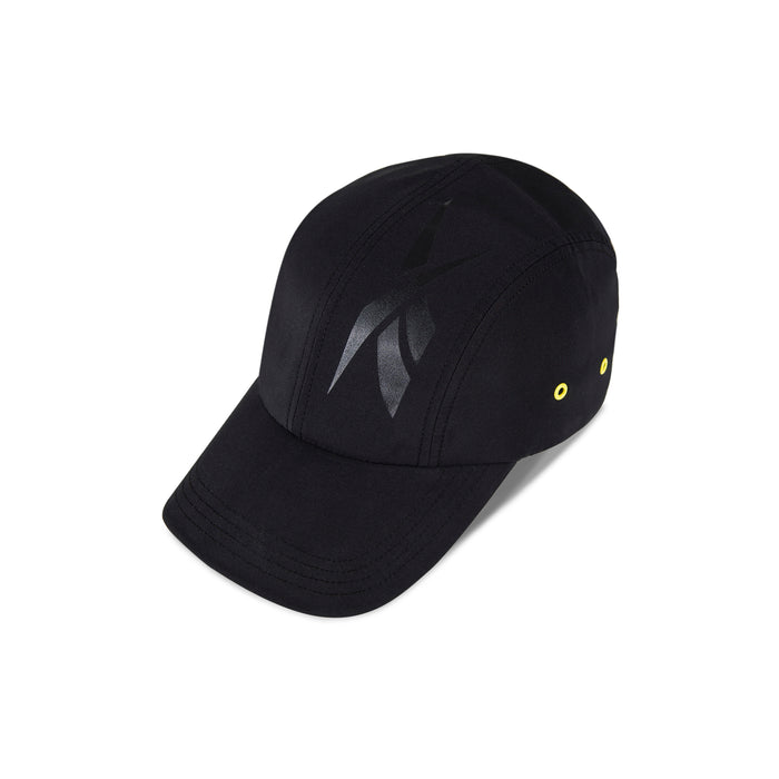 The Reebok Technical Running Cap With Drawcord, made from recycled materials, features a shiny black abstract front logo and two yellow side eyelets, displayed on a white background.