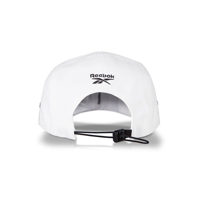 The image shows the back of the Reebok Technical Running Cap With Drawcord in white, made with recycled materials and featuring a black adjustable drawstring and an embroidered Reebok logo above the opening.