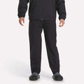 A person is shown from shoulders down wearing Reebok Track Pants, a black jacket, and black shoes against a plain white background.