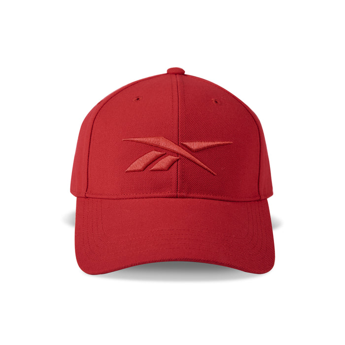 A red Reebok Vector Baseball Cap with a curved brim, tone-on-tone embroidered front logo, and adjustable snapback closure is shown on a white background.