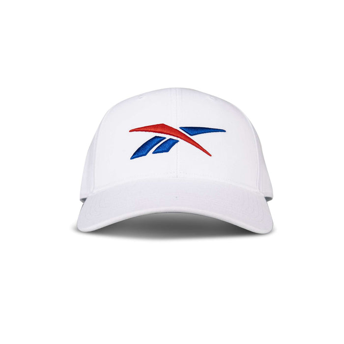 The Reebok Vector Baseball Cap, shown from the front against a white background, features a red and blue stylized logo on its white design.