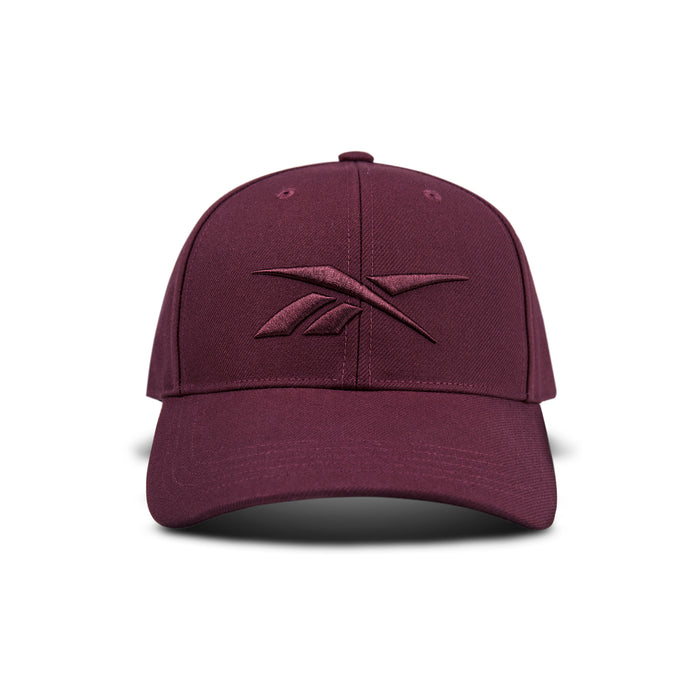 The Vector Baseball Cap by Reebok is maroon with a matching embroidered logo on the front, displayed against a white background.