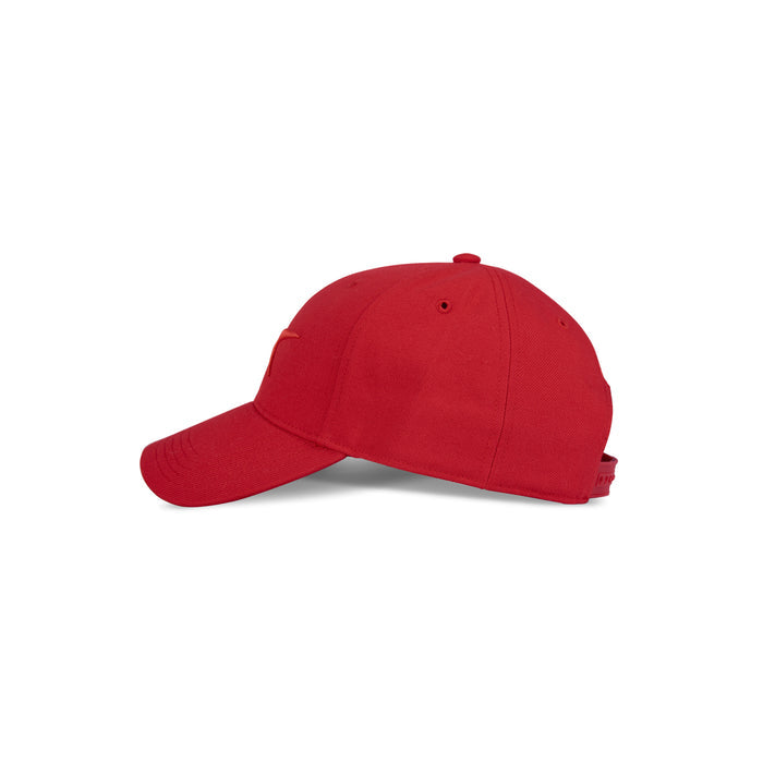 A side view of the Reebok Vector Baseball Cap in plain red highlights its curved brim and adjustable snapback closure, set against a white background.