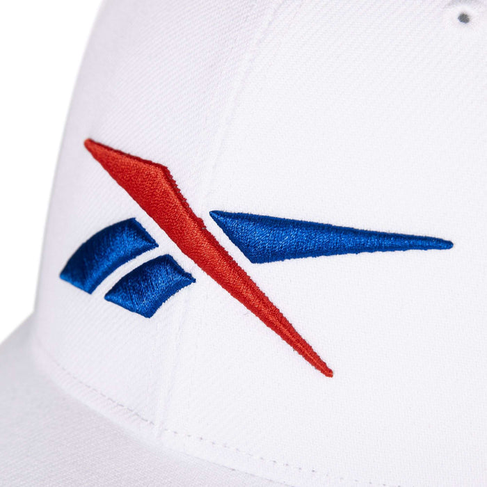 Close-up of the Reebok Vector Baseball Cap, showcasing an embroidered blue and red Reebok logo on the front.