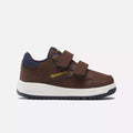 The Weebok Clasp Low Shoes by Reebok feature a brown design with navy accents, a Velcro strap, white sole, and gold Reebok logo—perfect for infants and toddlers’ daily wear. Shown on a white background.