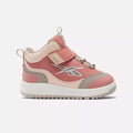 The Reebok Weebok Storm X Shoes for infants and toddlers feature pink and beige hues, a hook-and-loop strap, elastic laces, and a white sole—ideal comfort and style for little ones.